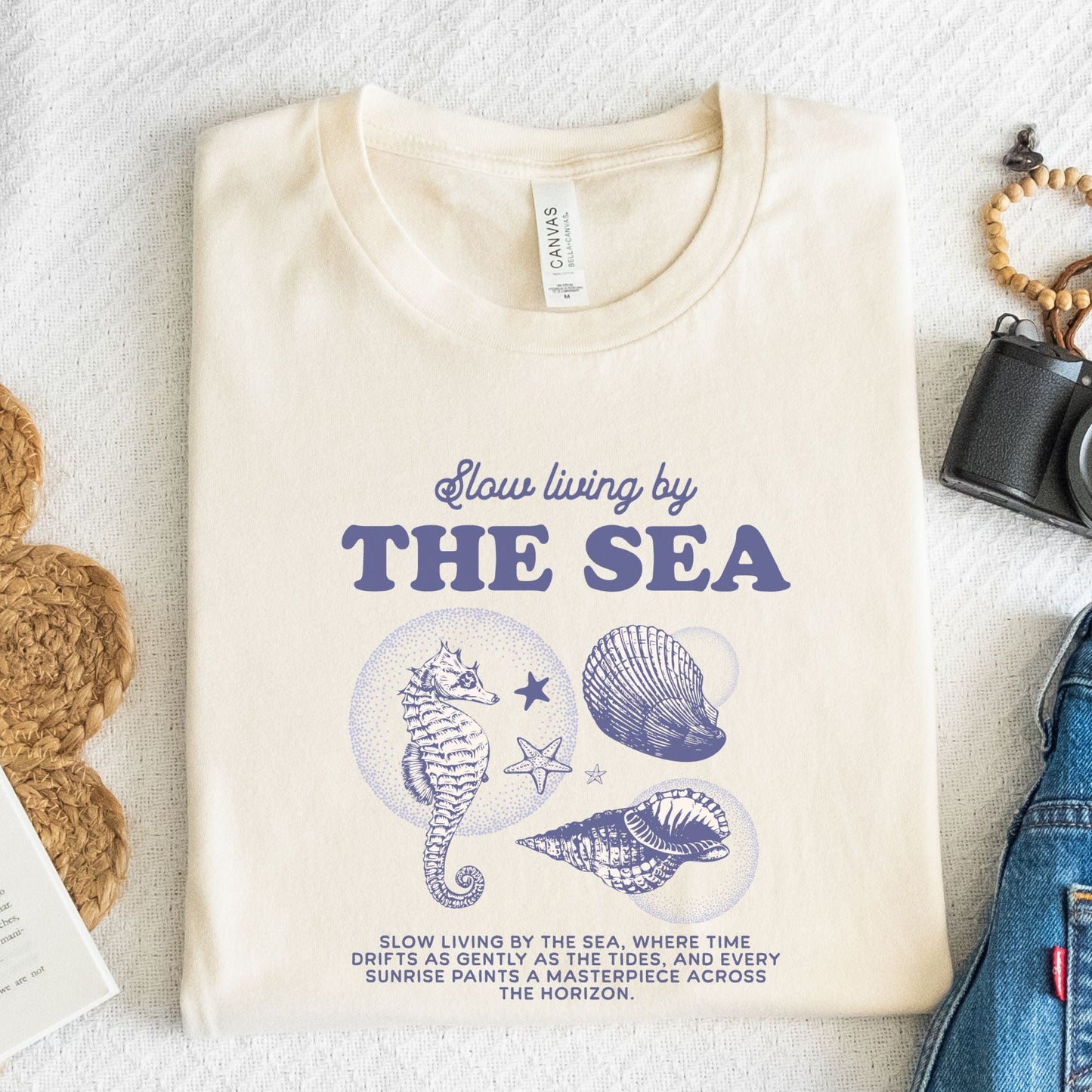 Vintage seahorse and shell graphic with "Slow Living by the Sea" text on t-shirt