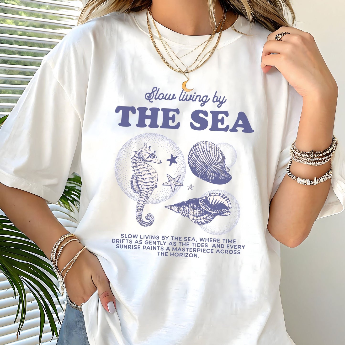 Vintage seahorse and shell graphic with "Slow Living by the Sea" text on t-shirt