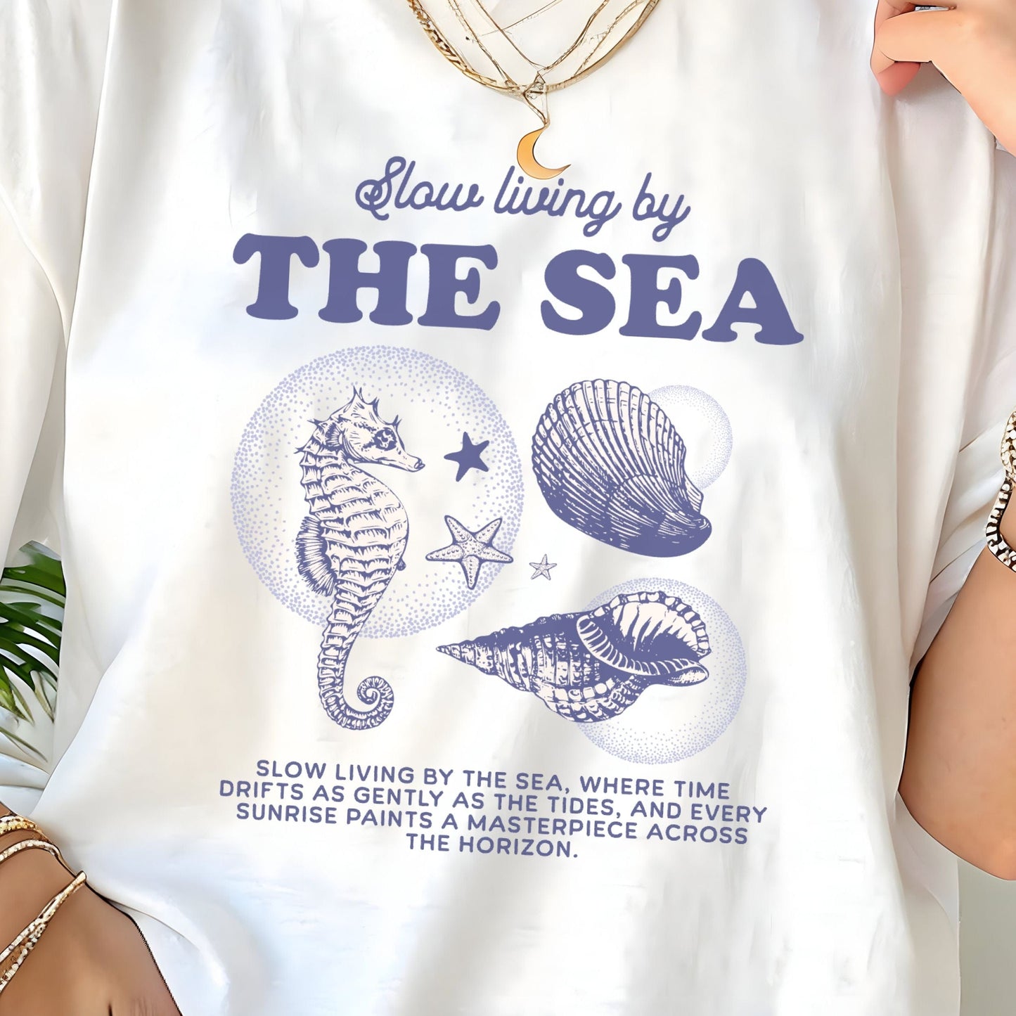 Vintage seahorse and shell graphic with "Slow Living by the Sea" text on t-shirt