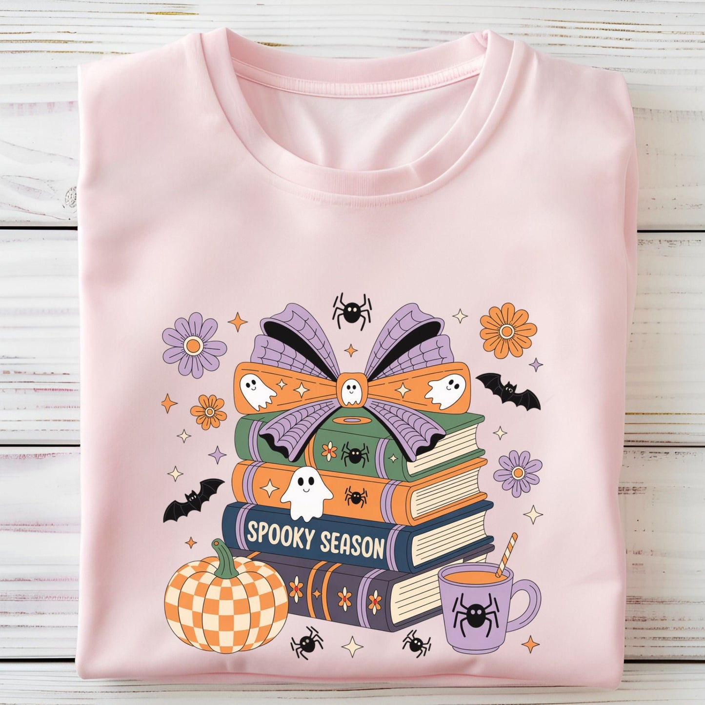 Halloween t-shirt with colorful stack of books, ghosts, pumpkin, and coffee cup reading “Spooky Season.”