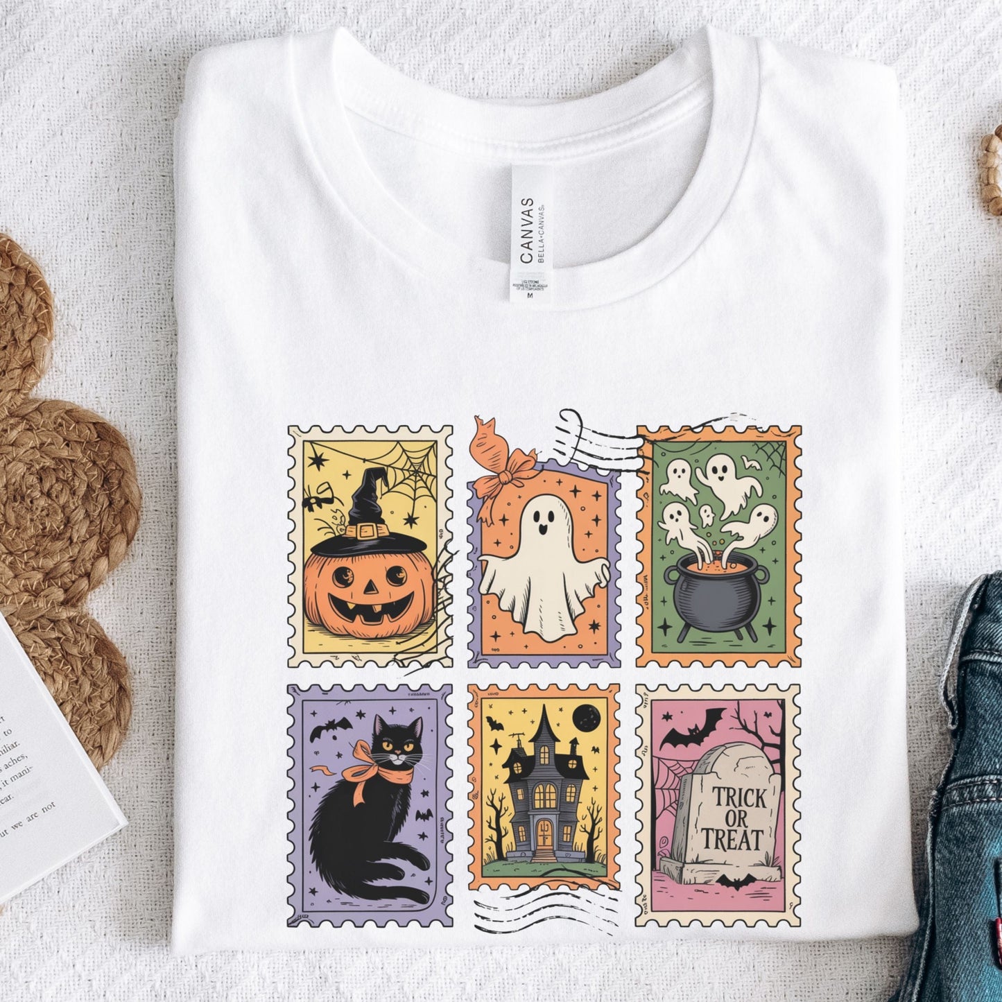 Vintage Halloween t-shirt with postage stamp illustrations of ghosts, pumpkins, black cat, haunted house, and trick-or-treat