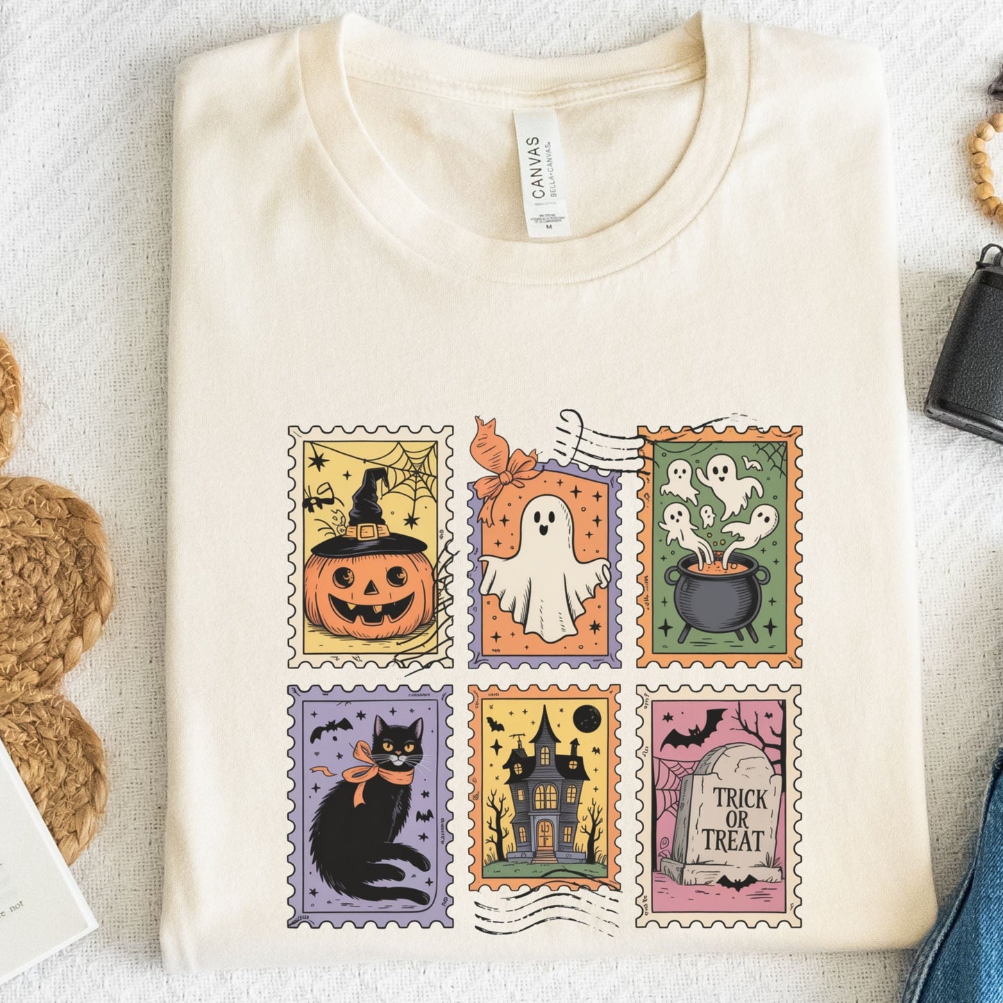 Vintage Halloween t-shirt with postage stamp illustrations of ghosts, pumpkins, black cat, haunted house, and trick-or-treat