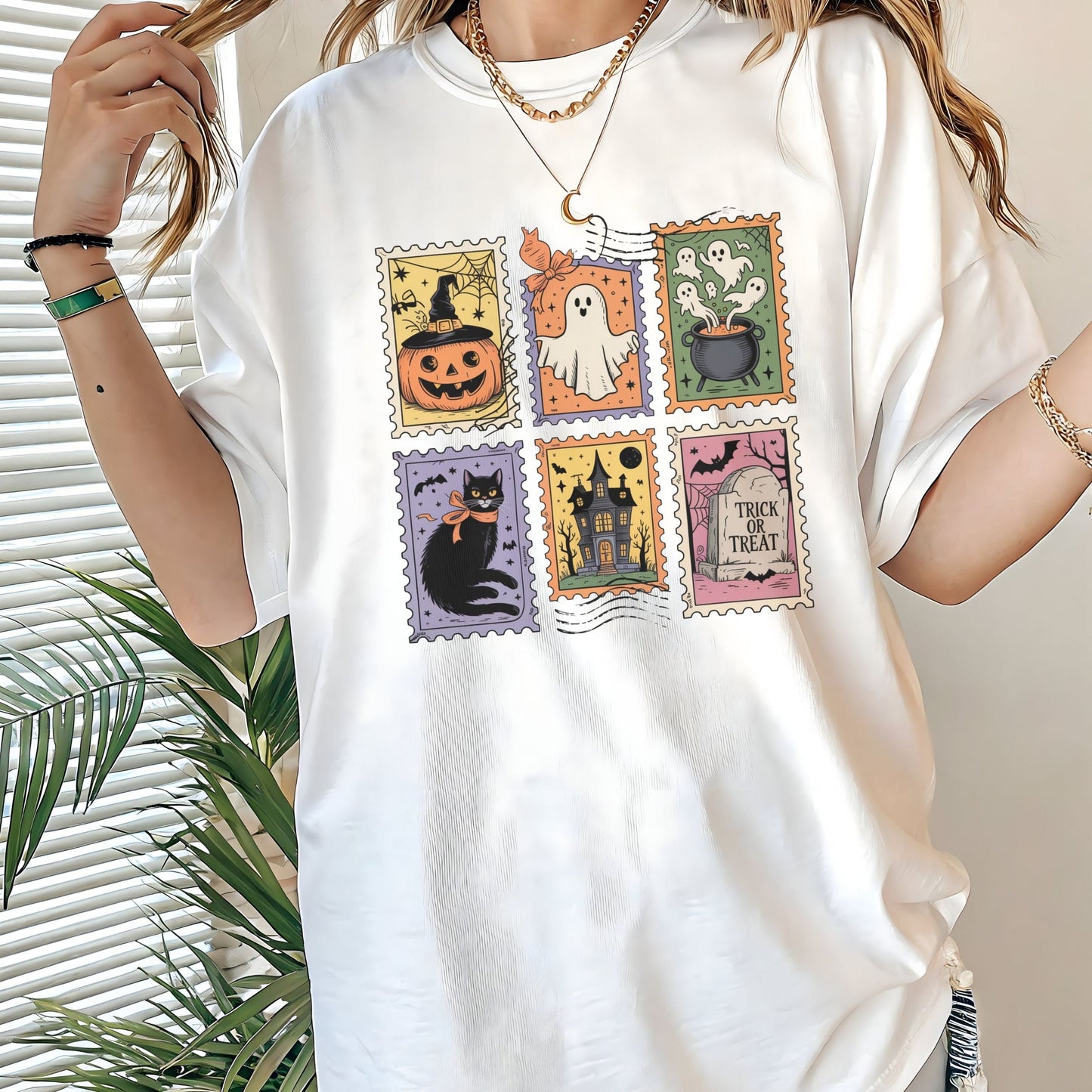 Vintage Halloween t-shirt with postage stamp illustrations of ghosts, pumpkins, black cat, haunted house, and trick-or-treat