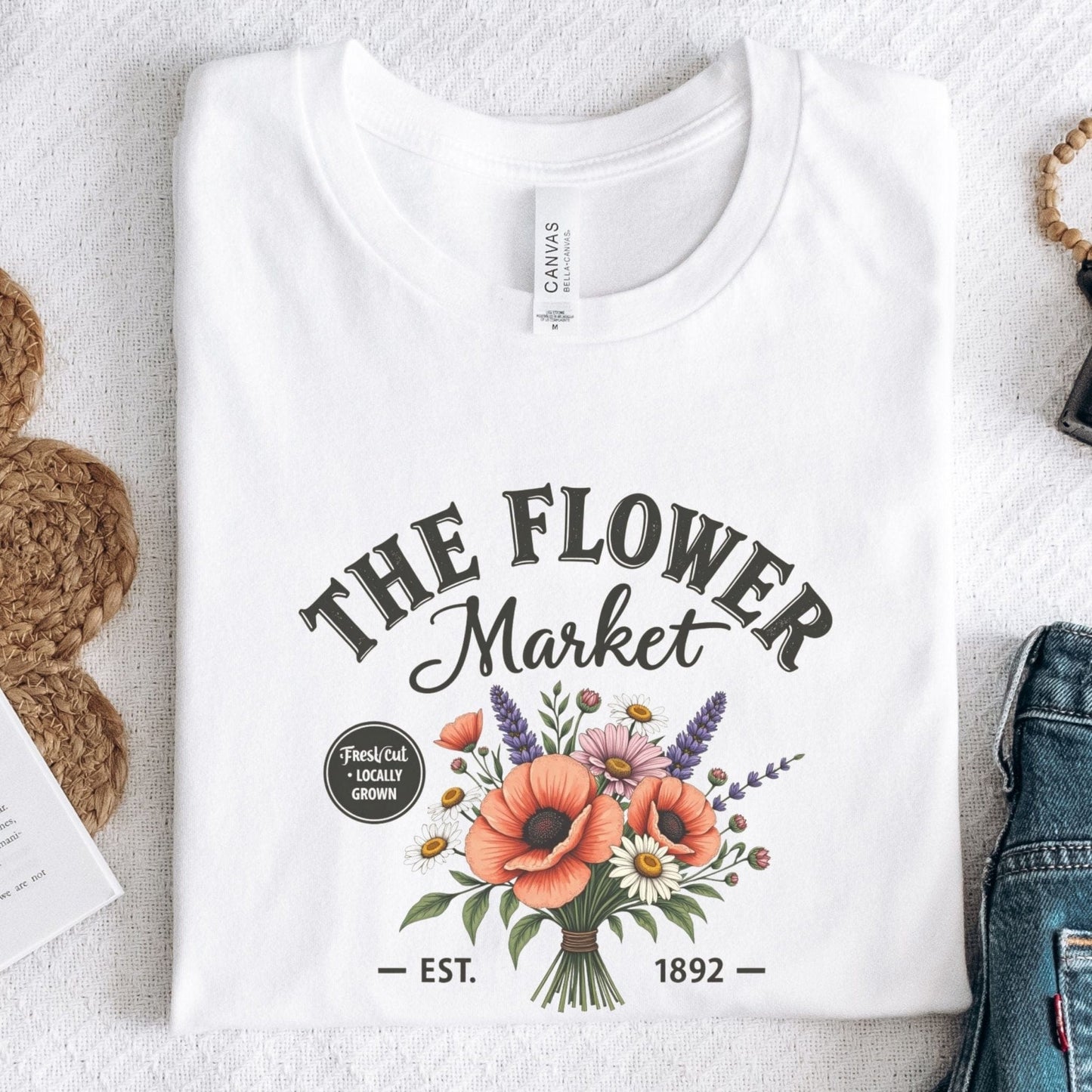 “The Flower Market” t-shirt with vintage typography and a bouquet of poppies, daisies, lavender, and wildflowers, featuring “Fresh Cut • Locally Grown.”