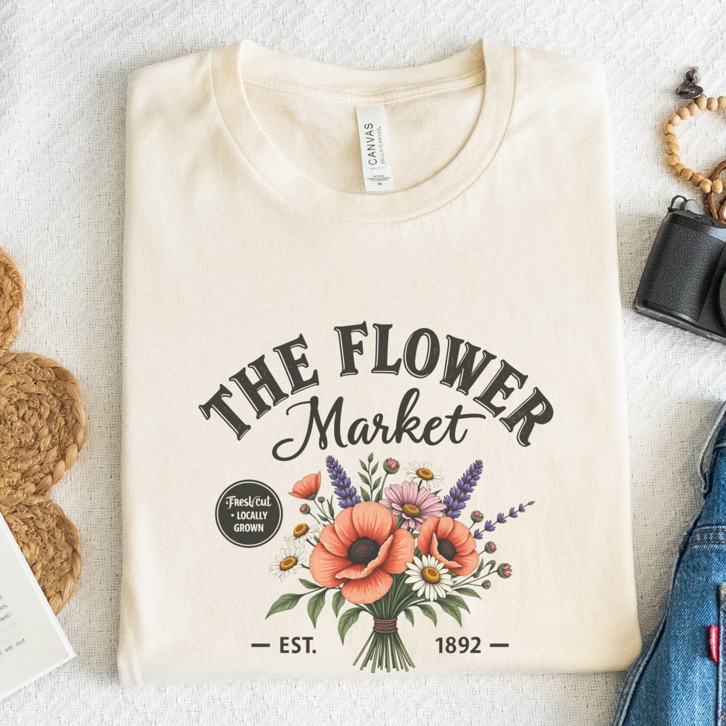 “The Flower Market” t-shirt with vintage typography and a bouquet of poppies, daisies, lavender, and wildflowers, featuring “Fresh Cut • Locally Grown.”