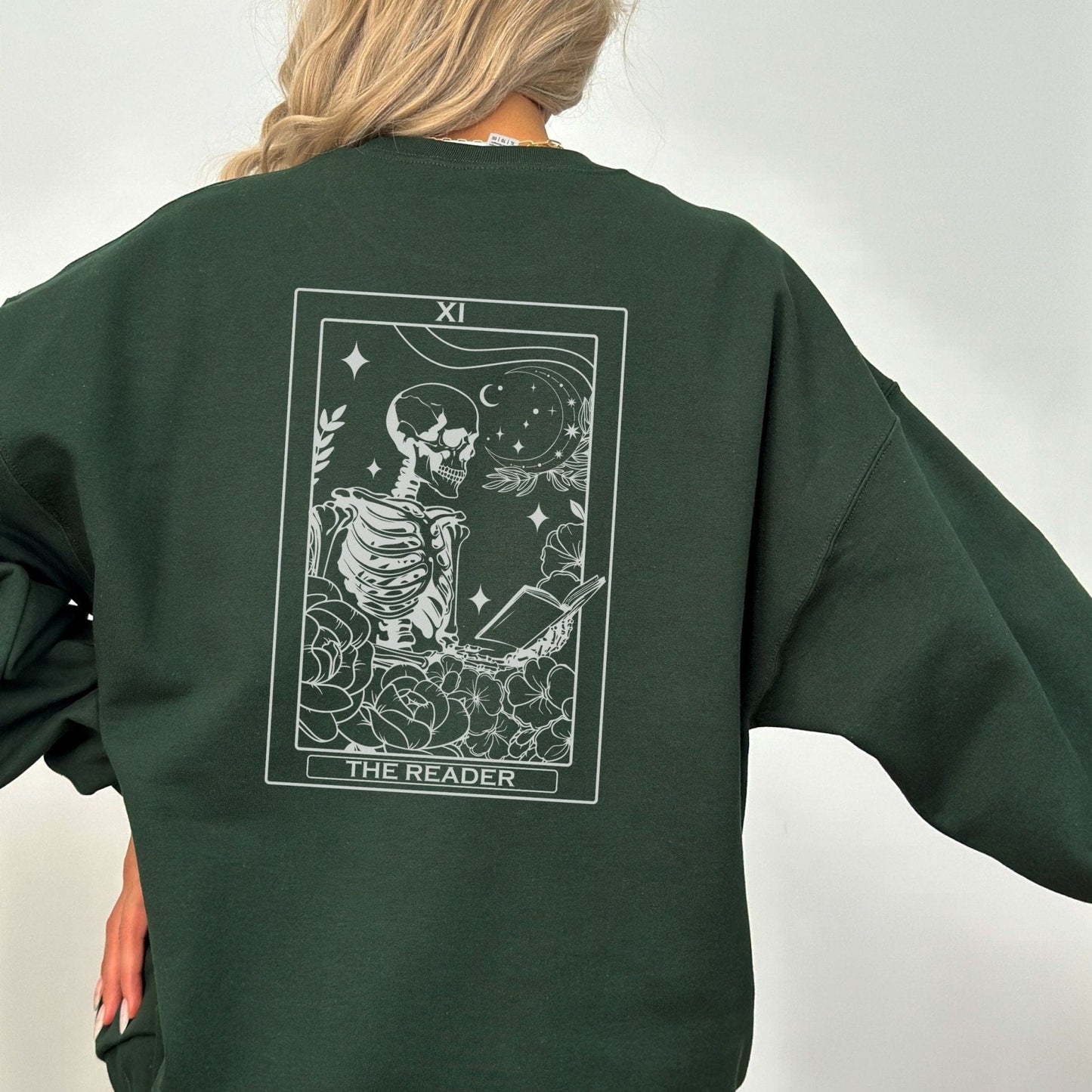 “The Reader Tarot” sweatshirt with mystical tarot card illustration printed on the back, perfect for book lovers and cozy fall vibes.