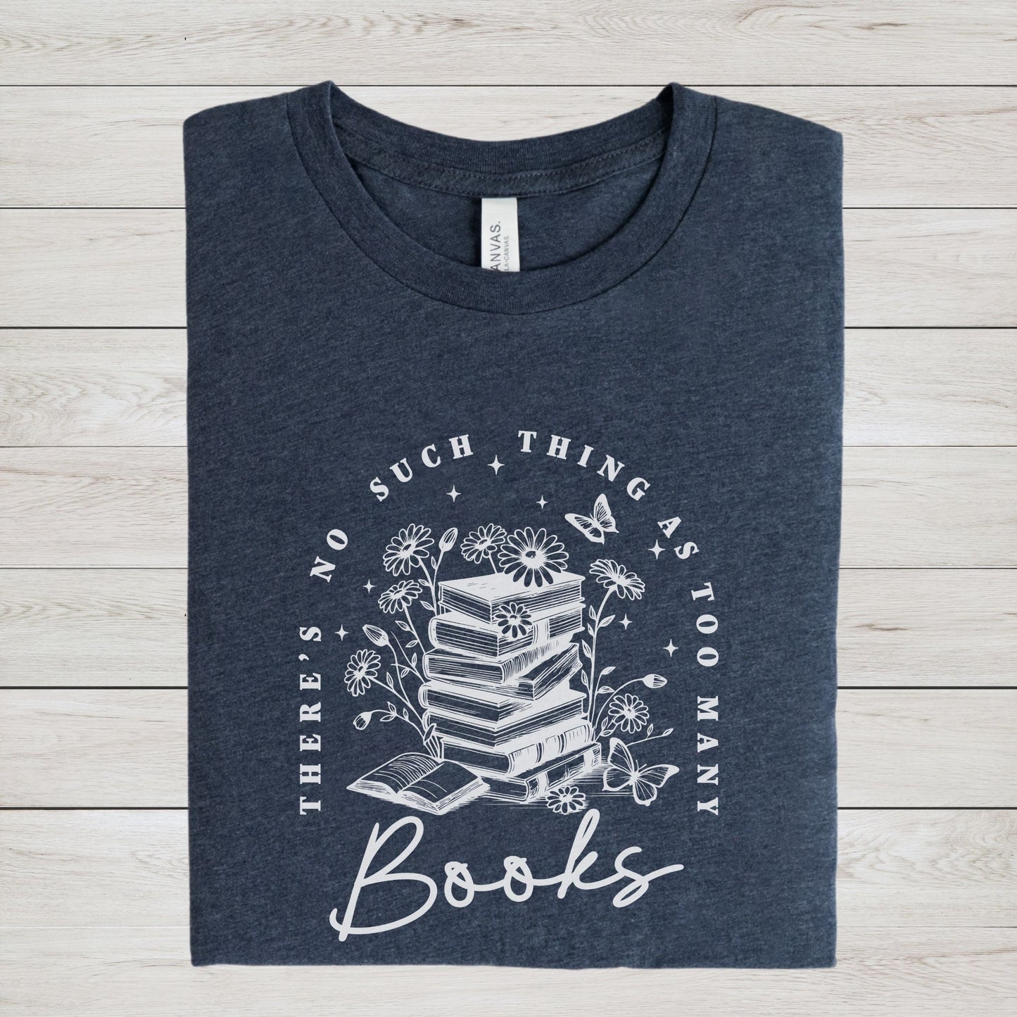 “Too Many Books, Not Enough Time” t-shirt with minimalist stacked books and handwritten lettering in black line art style.