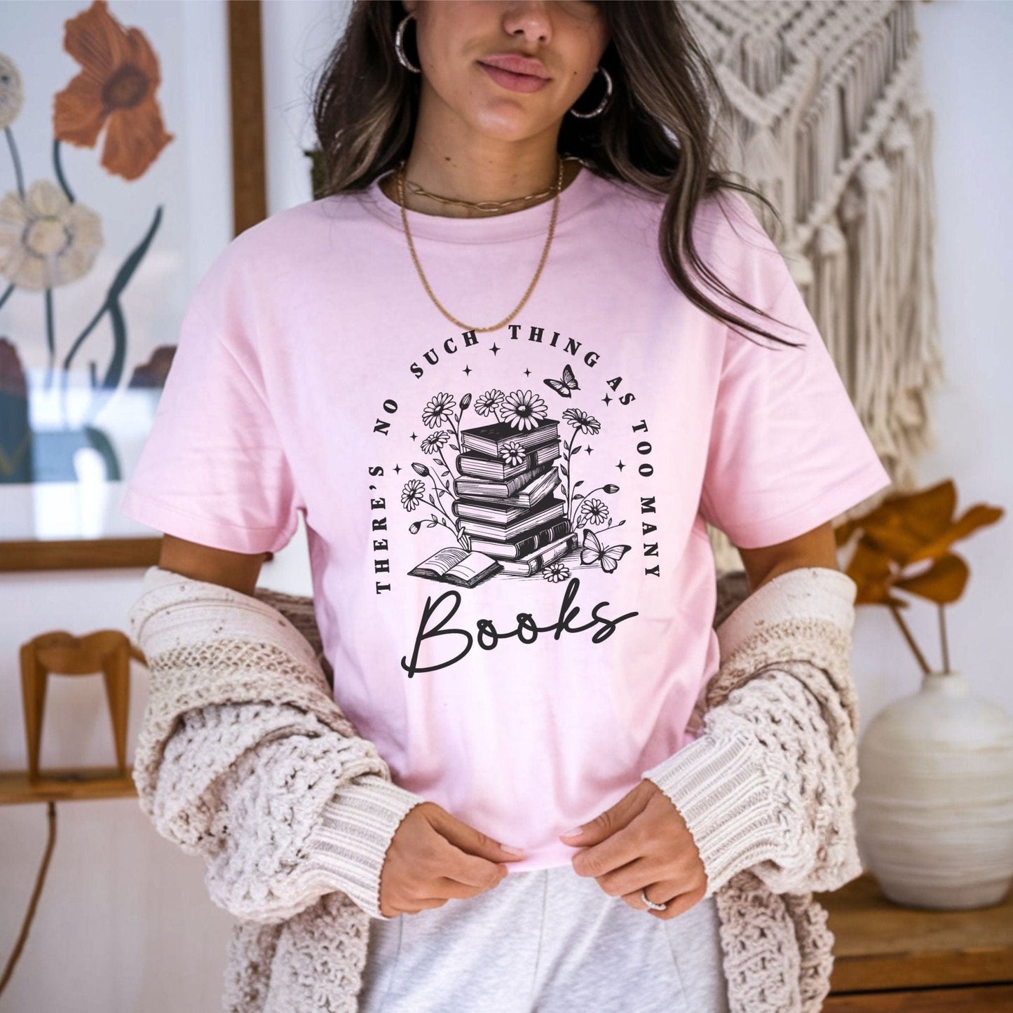 “Too Many Books, Not Enough Time” t-shirt with minimalist stacked books and handwritten lettering in black line art style.