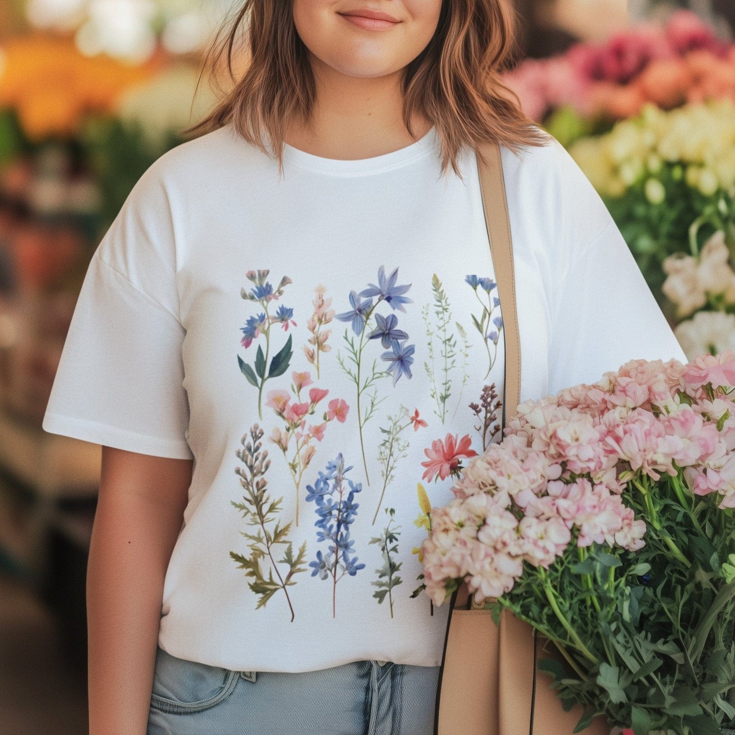 Vintage wildflower t-shirt featuring hand-drawn pastel florals in soft pinks, blues, and yellows arranged in a scattered botanical layout.