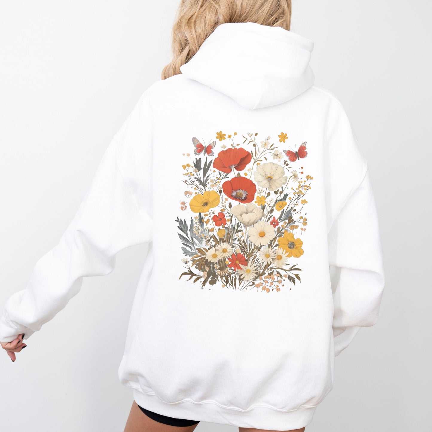 Back of hoodie with vintage wildflower bouquet and butterflies — cozy spring sweatshirt for floral lovers.