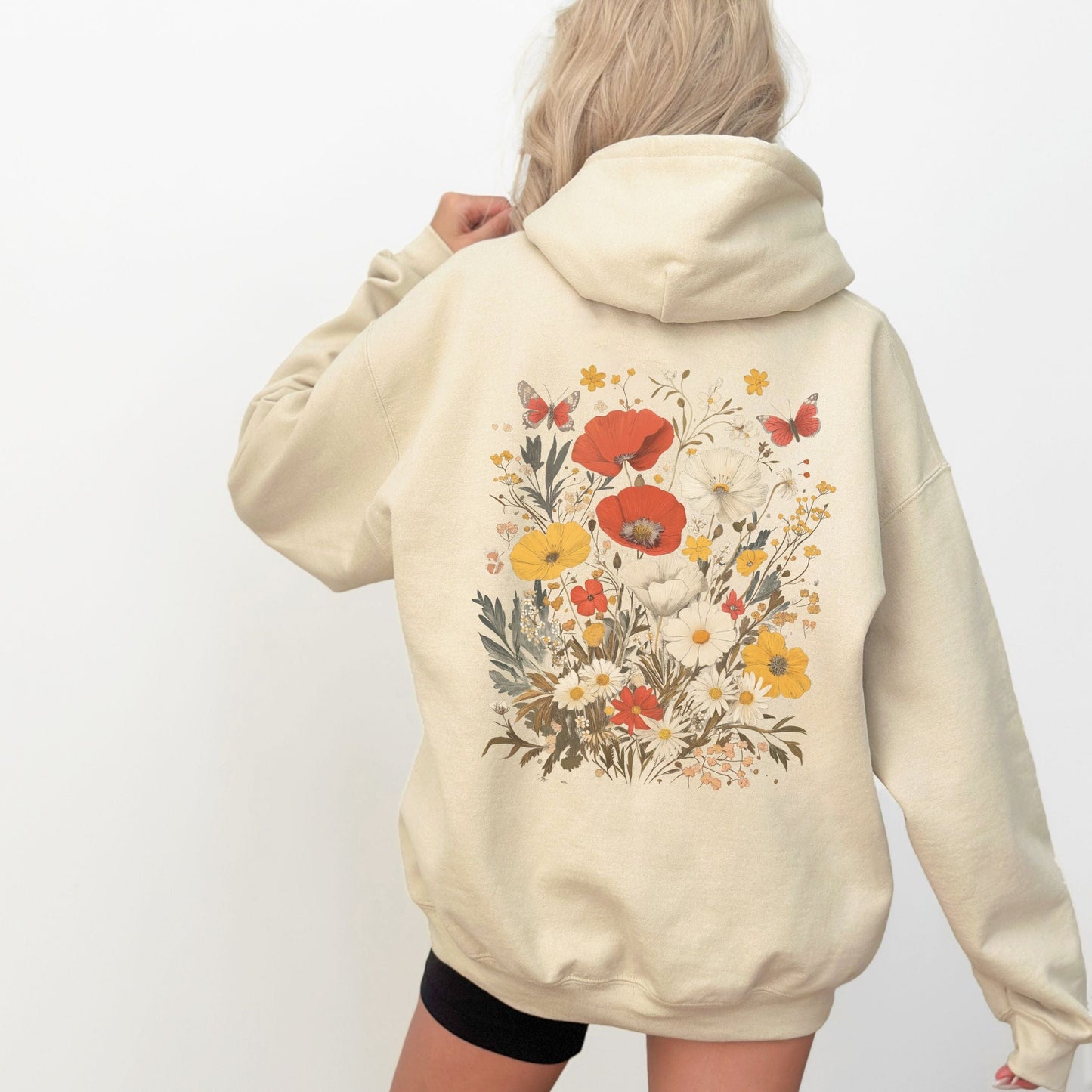 Back of hoodie with vintage wildflower bouquet and butterflies — cozy spring sweatshirt for floral lovers.