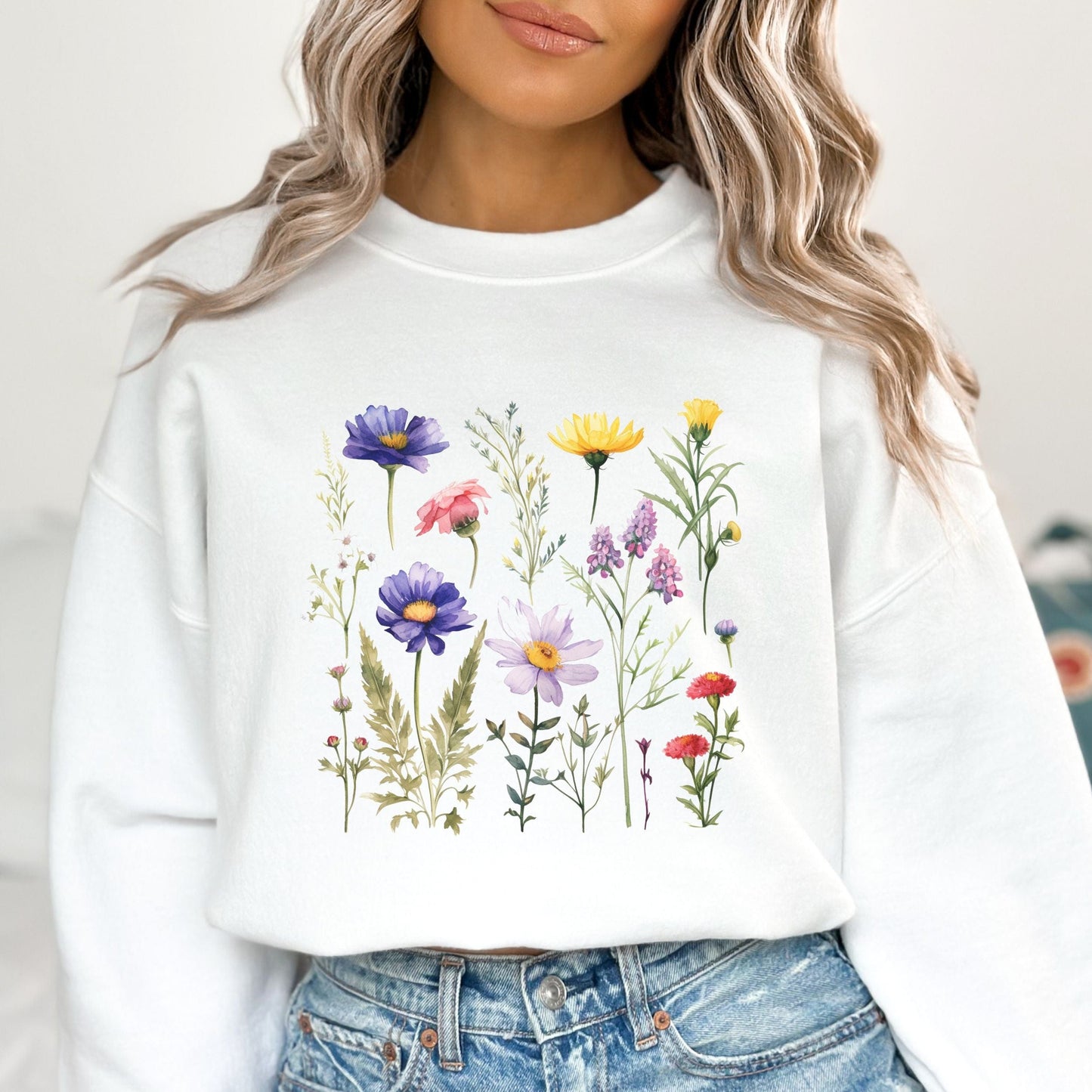 Vintage-style wildflower garden design on a cozy sweatshirt in soft spring tones
