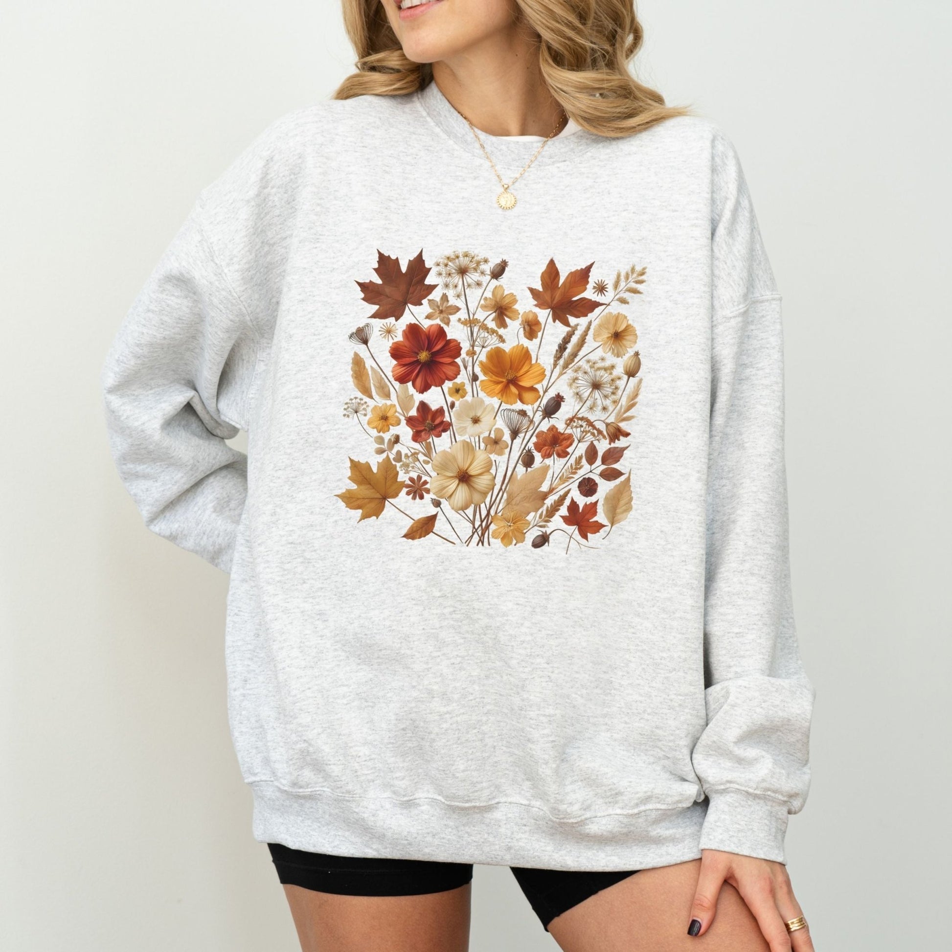 Fall floral sweatshirt with wildflower and autumn leaf design.