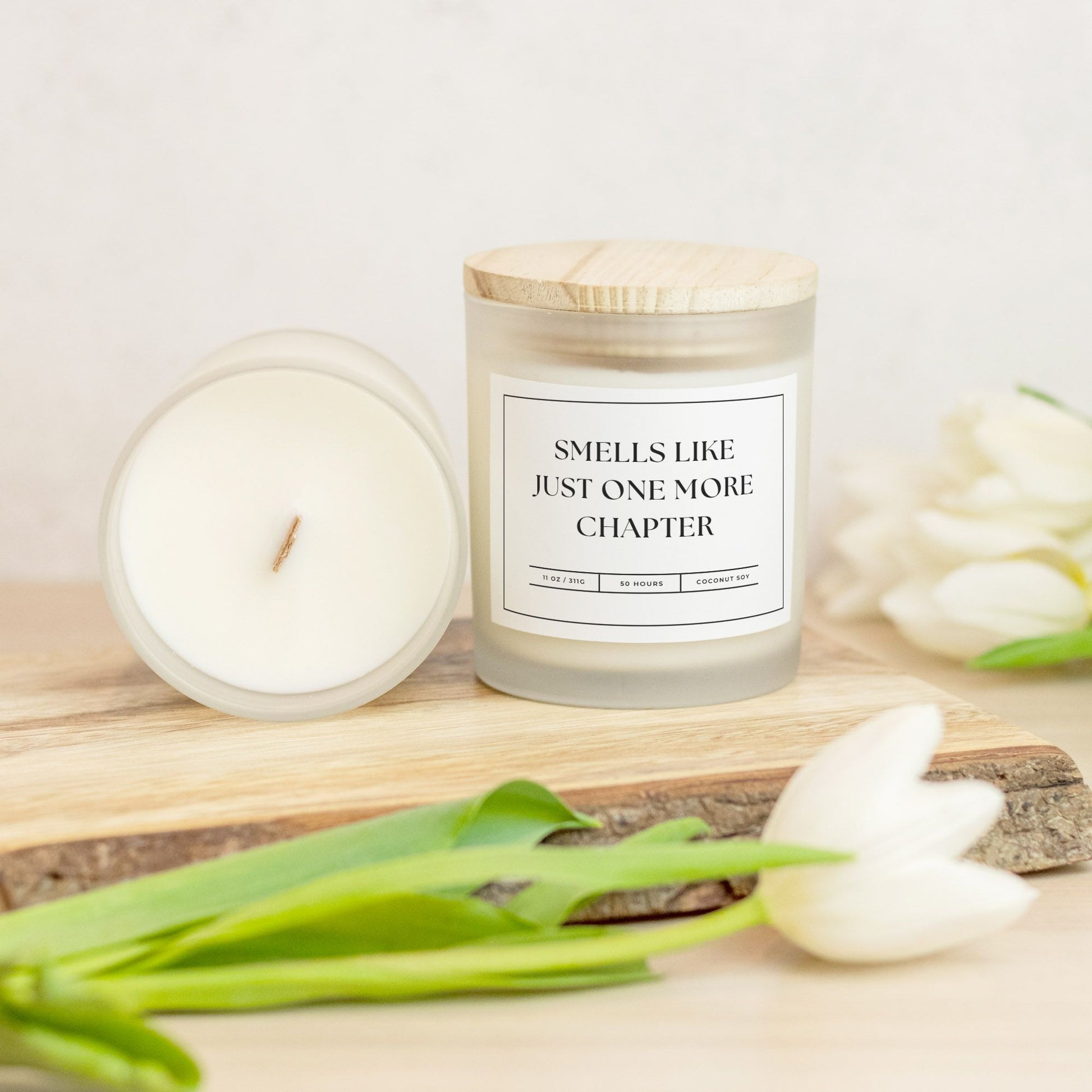 11 oz frosted glass candle with "Smells Like Just One More Chapter" design, perfect for book lovers and cozy nights.