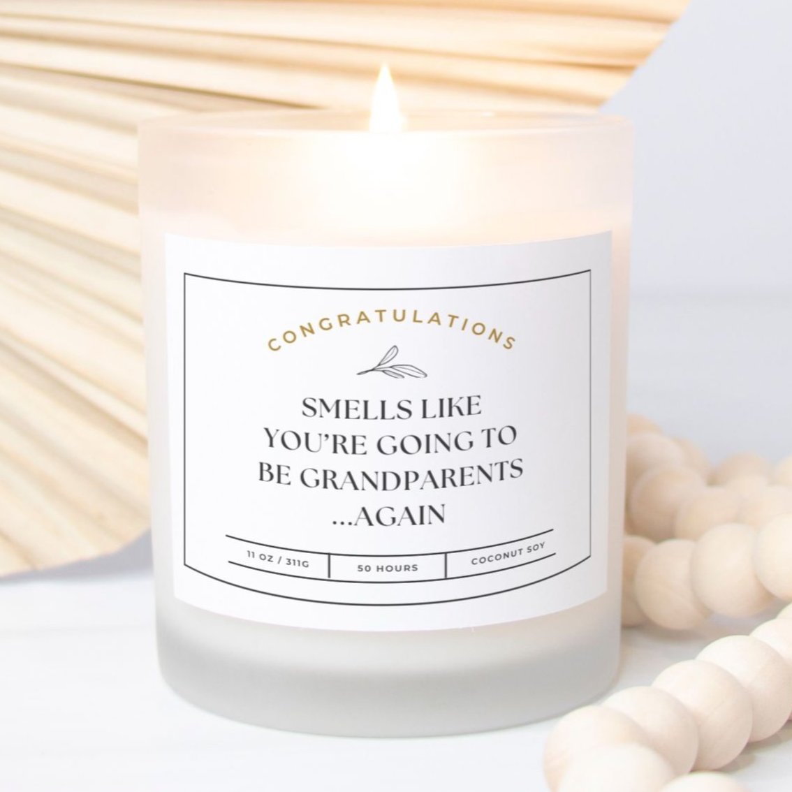 Frosted glass candle with "Smells Like You’re Going to Be Grandparents...Again" design.