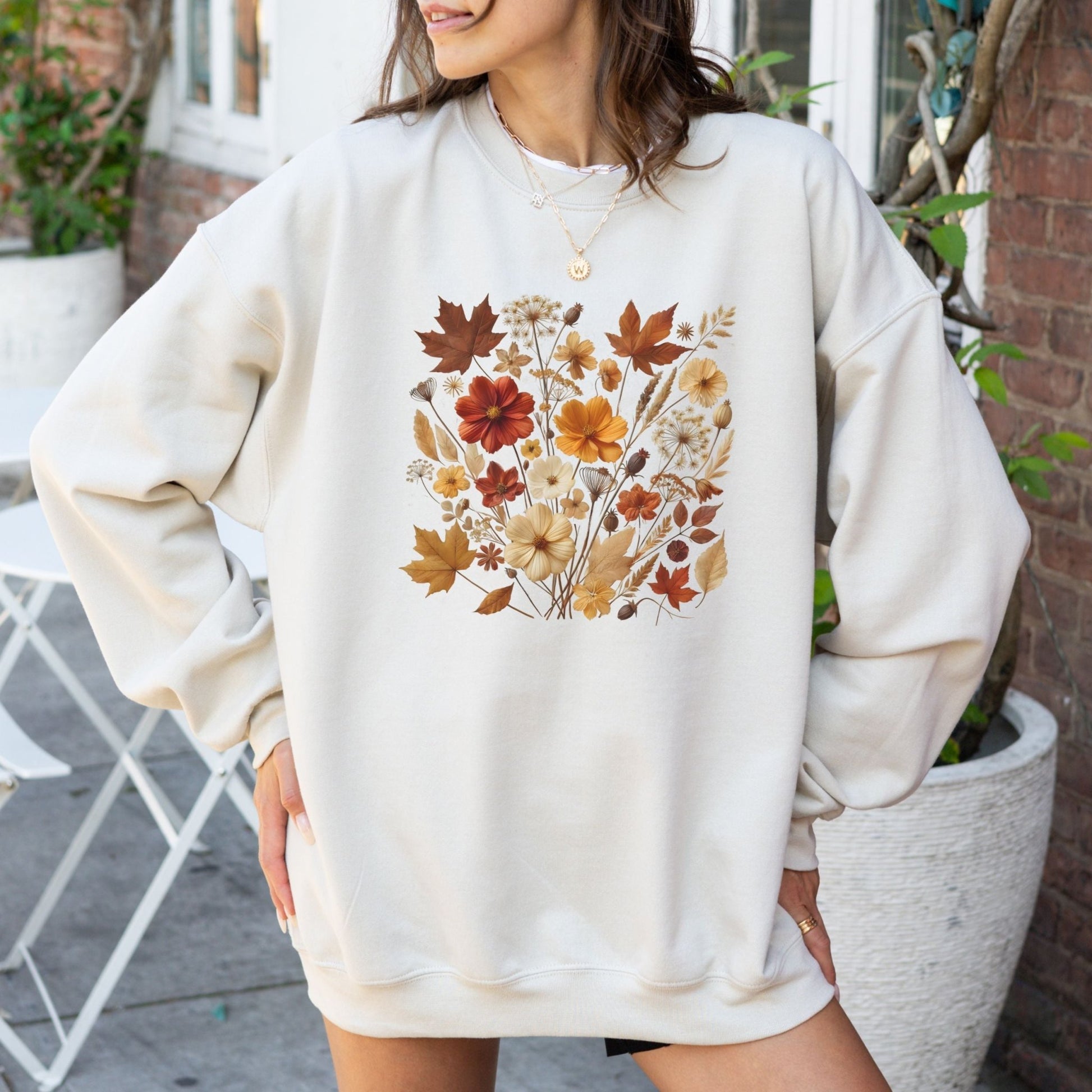 Fall floral sweatshirt with wildflower and autumn leaf design.