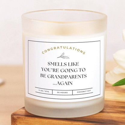 Frosted glass candle with "Smells Like You’re Going to Be Grandparents...Again" design.