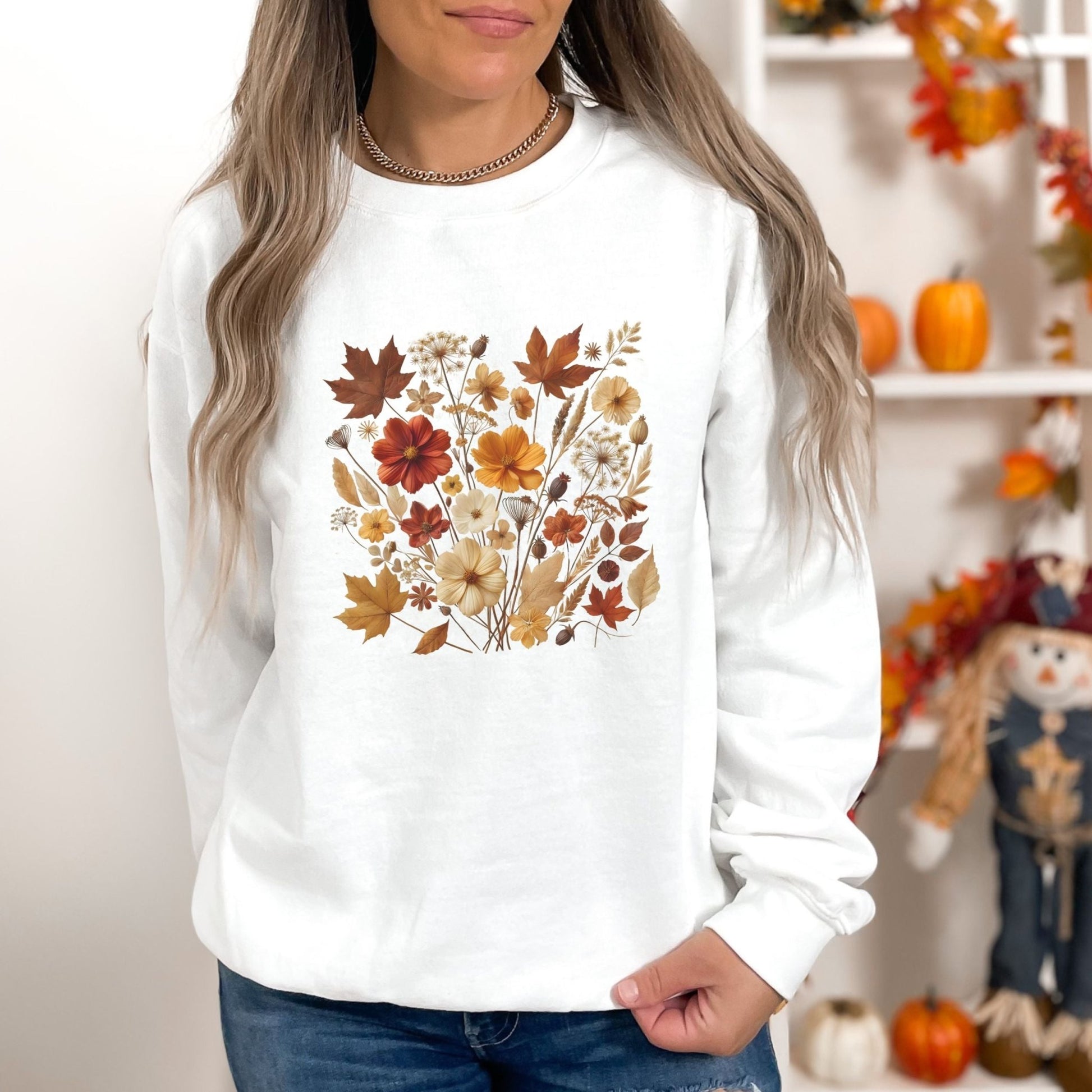 Fall floral sweatshirt with wildflower and autumn leaf design.