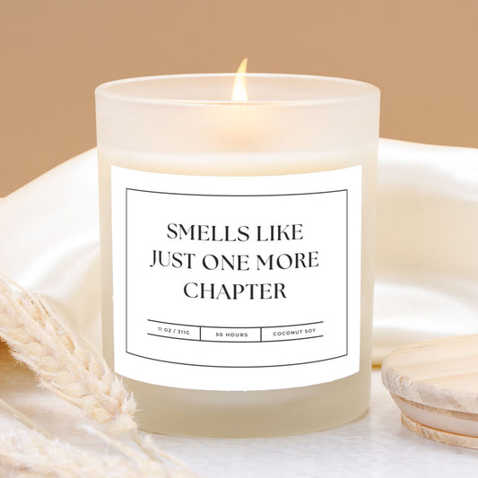 11 oz frosted glass candle with "Smells Like Just One More Chapter" design, perfect for book lovers and cozy nights.