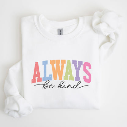 Retro rainbow “Always Be Kind” sweatshirt design with bold varsity letters in pastel colors and script font underneath on a cozy fleece pullover.