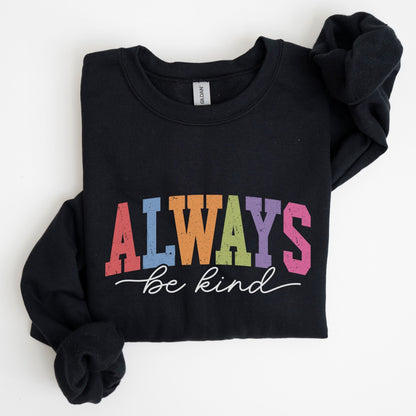 Retro rainbow “Always Be Kind” sweatshirt design with bold varsity letters in pastel colors and script font underneath on a cozy fleece pullover.