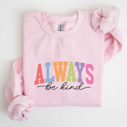 Retro rainbow “Always Be Kind” sweatshirt design with bold varsity letters in pastel colors and script font underneath on a cozy fleece pullover.
