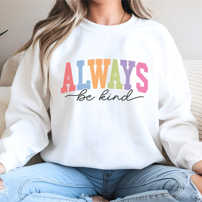 Retro rainbow “Always Be Kind” sweatshirt design with bold varsity letters in pastel colors and script font underneath on a cozy fleece pullover.