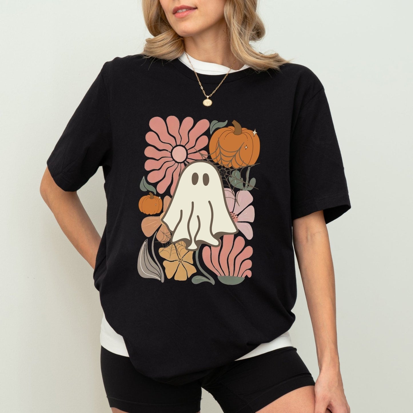 Halloween shirt with cute ghost, pumpkins, and retro floral design.