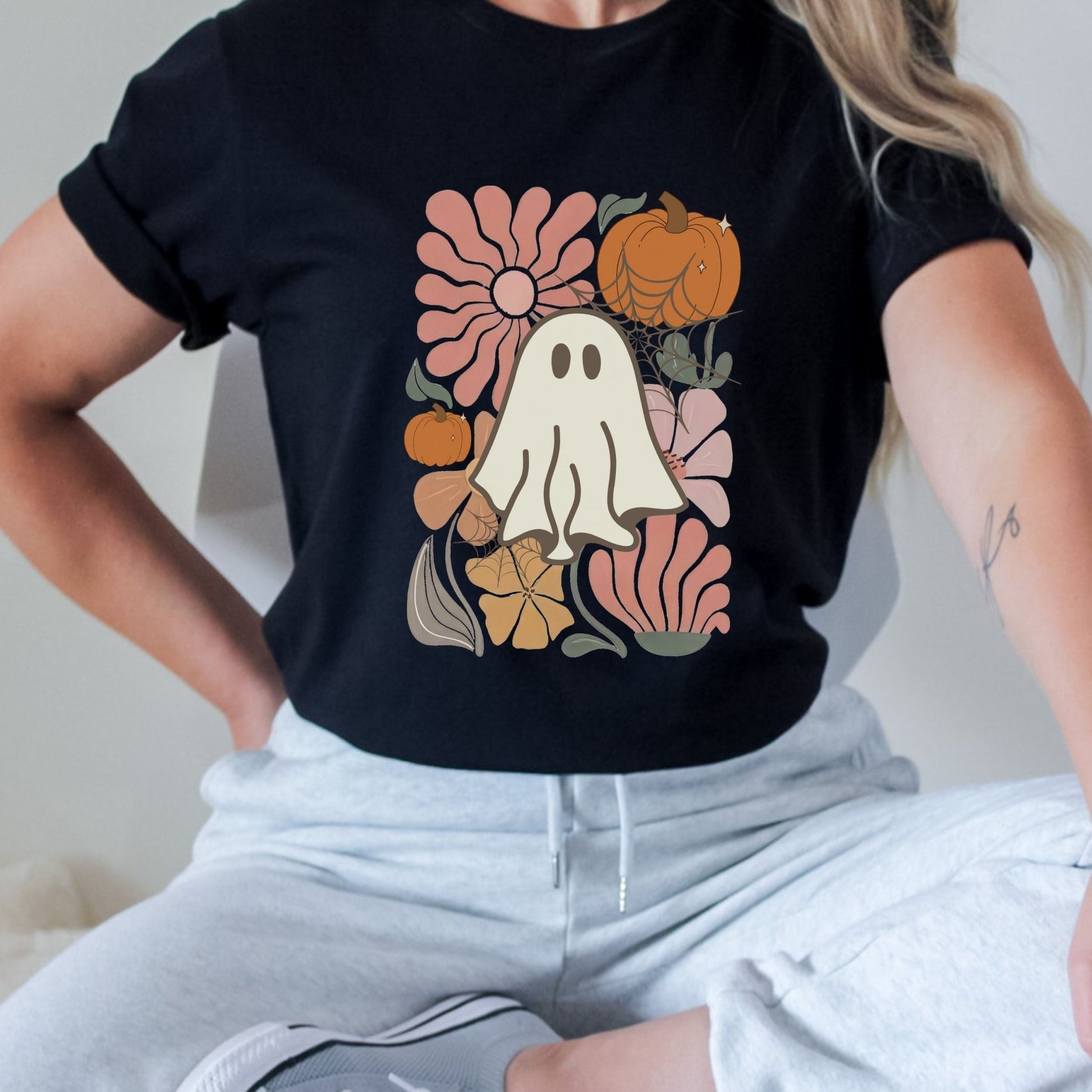 Halloween shirt with cute ghost, pumpkins, and retro floral design.