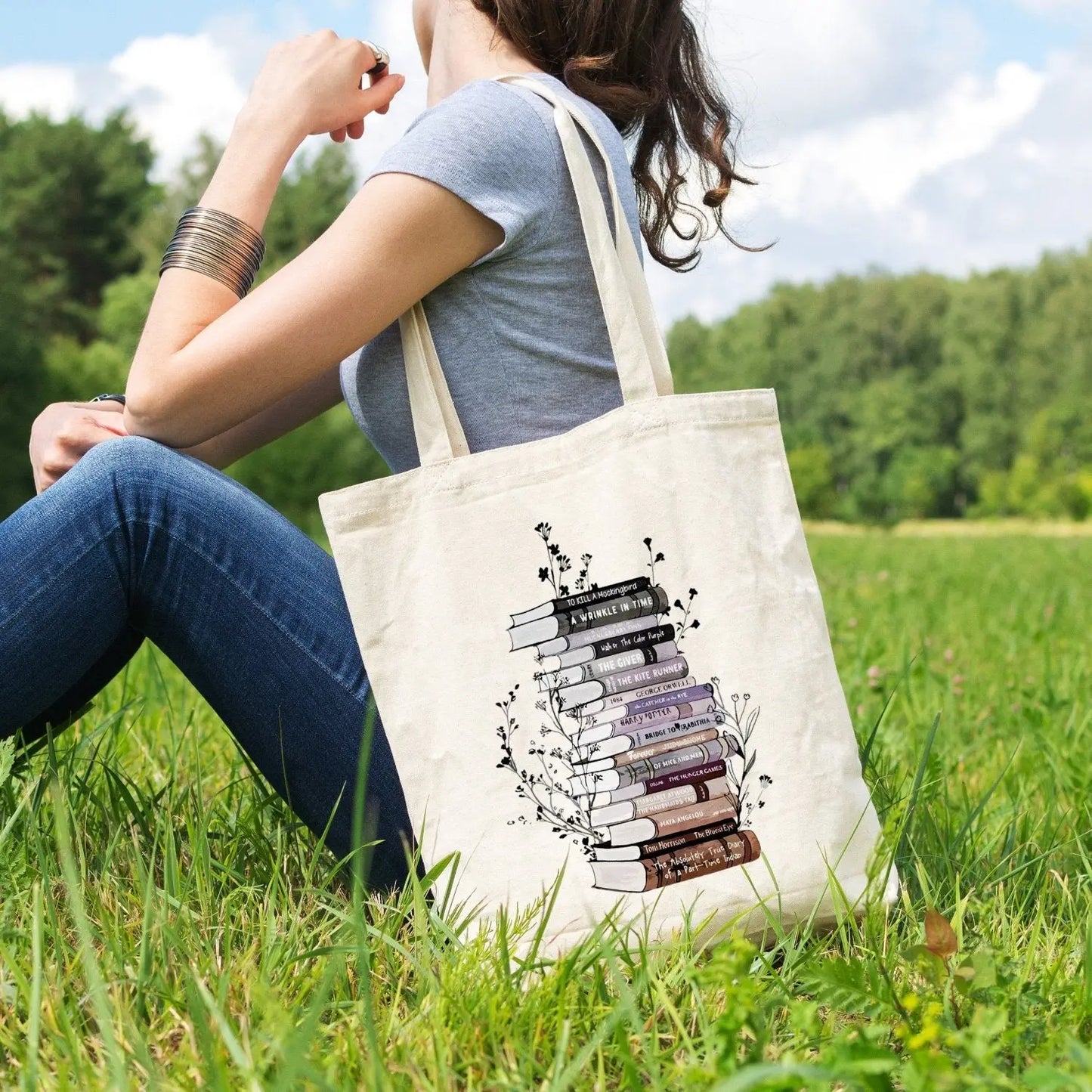 Cotton canvas tote bag with floral book stack design, perfect book lover gift.