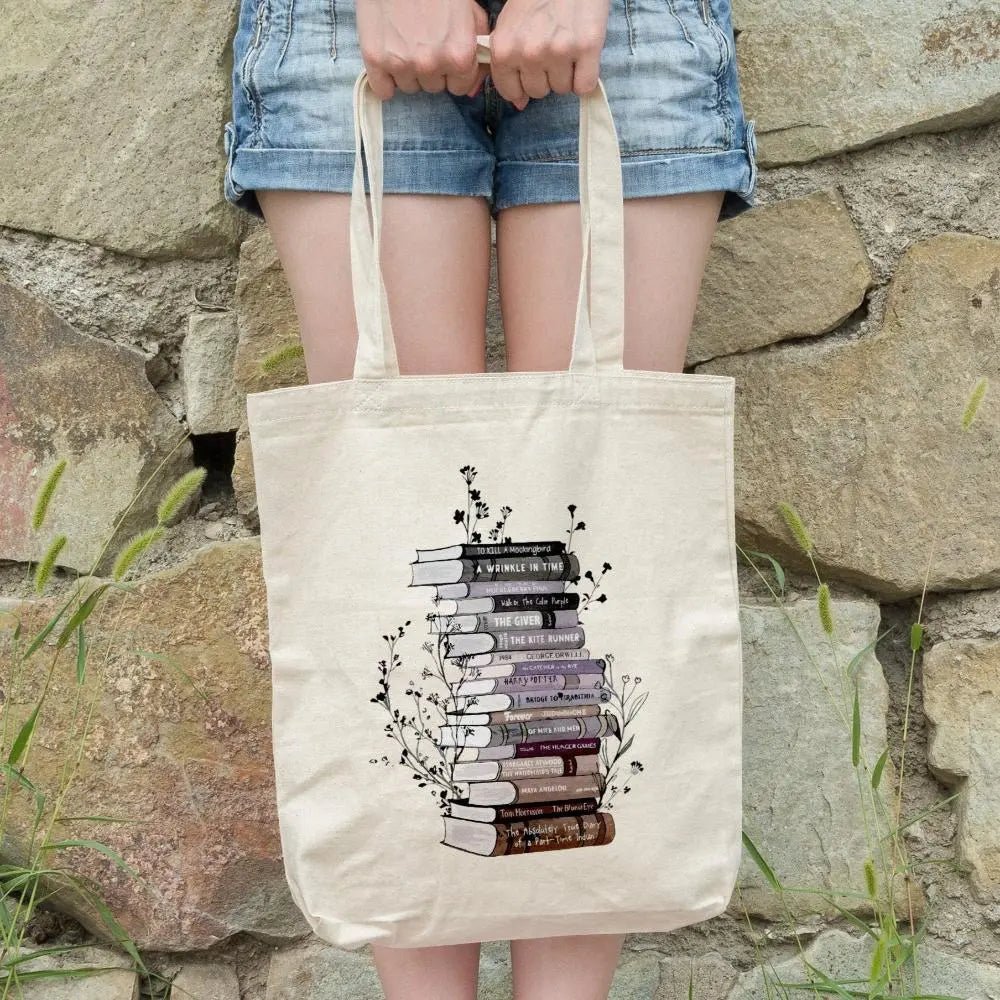 Cotton canvas tote bag with floral book stack design, perfect book lover gift.