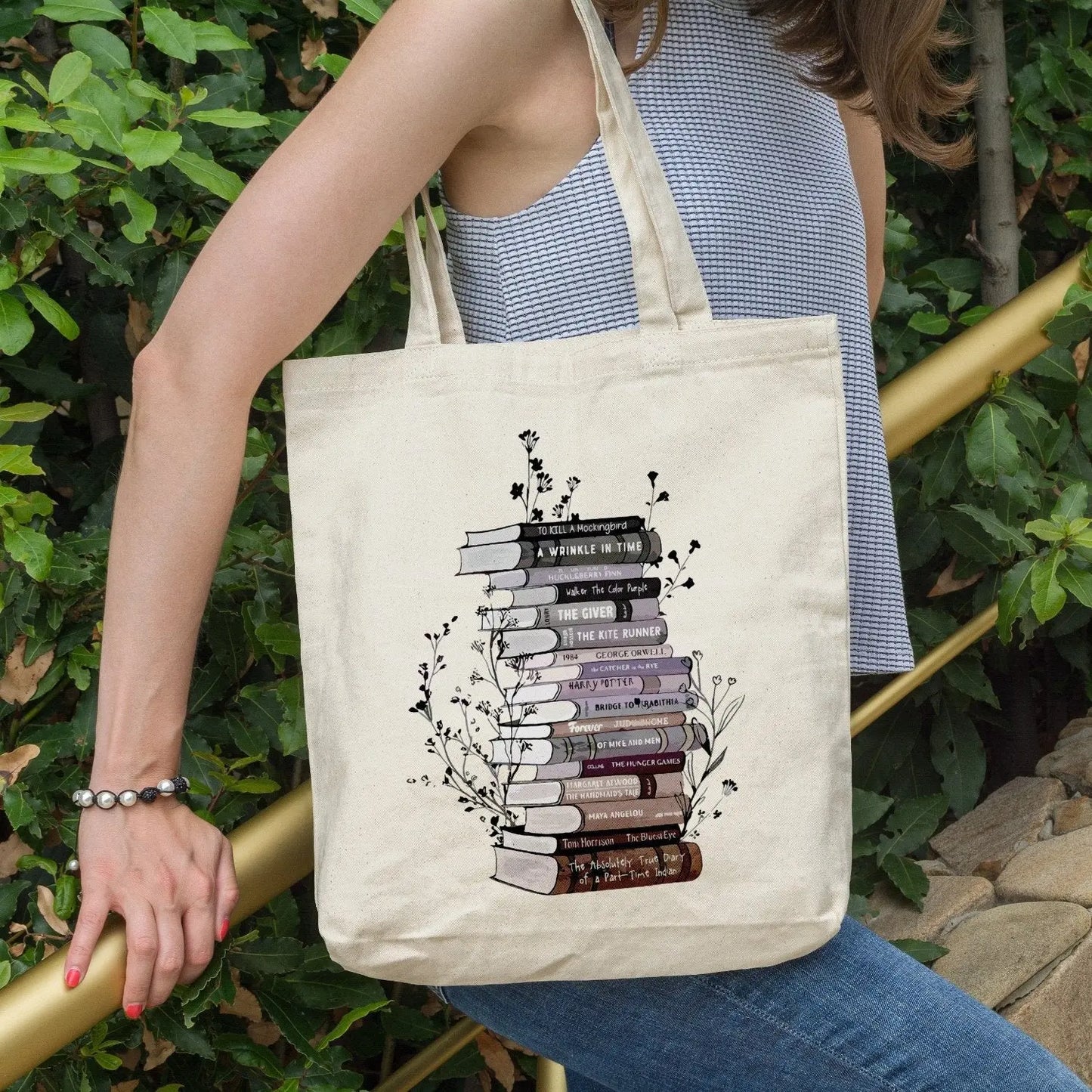 Cotton canvas tote bag with floral book stack design, perfect book lover gift.