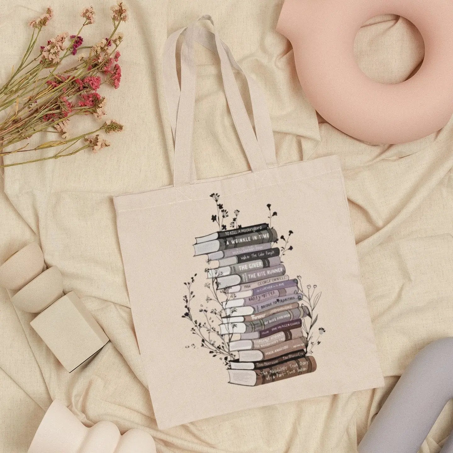 Cotton canvas tote bag with floral book stack design, perfect book lover gift.