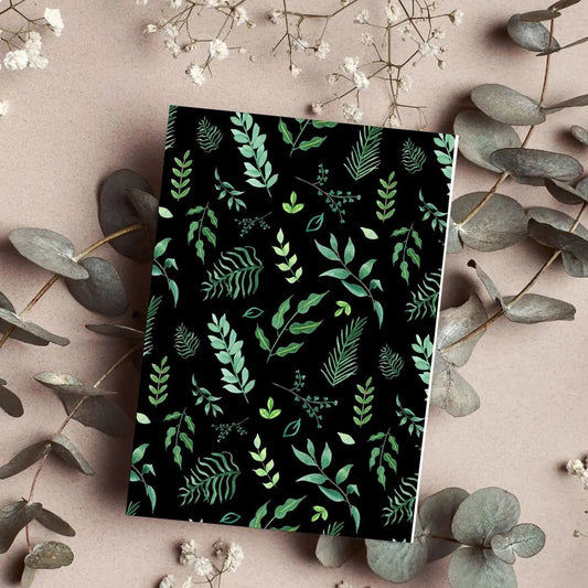 Blank notebook with botanical leaf pattern and greenery design, perfect for nature lovers.