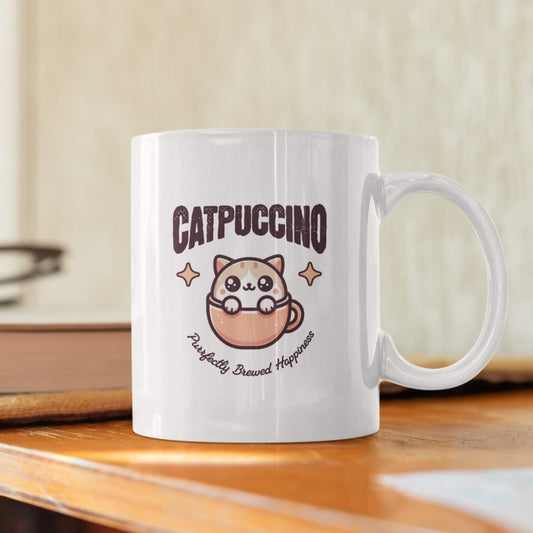 Cute cat coffee mug with "Catpuccino" design, perfect for cat and coffee lovers.