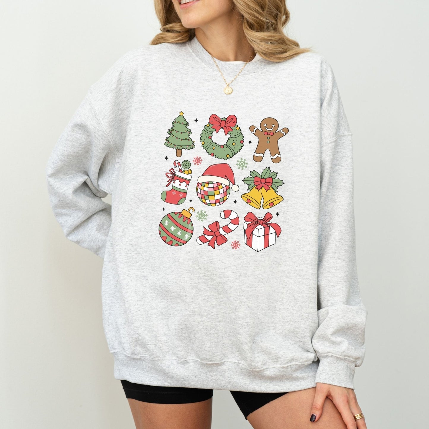 Christmas sweatshirt with festive holiday icons like trees, wreaths, and gingerbread men. Comes in 6 colors, perfect for cozy winter wear.