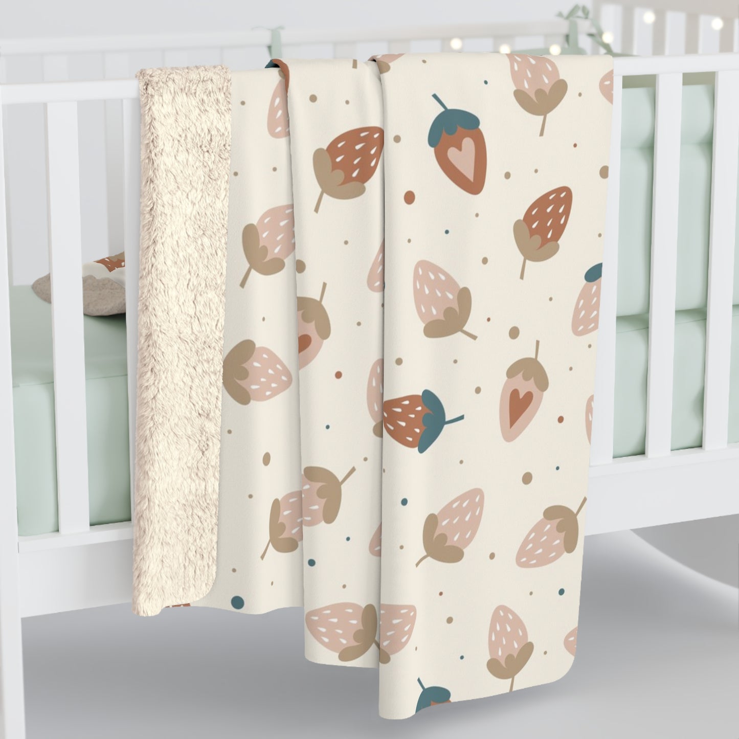 Pastel strawberry baby blanket with whimsical berry design, ideal for cozy nursery decor.