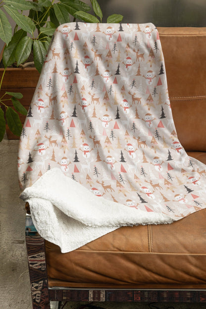 Cozy Christmas blanket with reindeer, snowman, and tree designs, perfect for holiday decor.