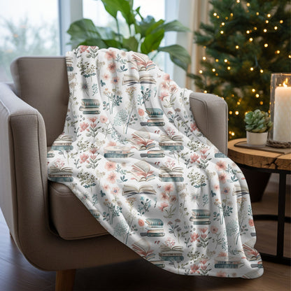 Cozy floral book-themed blanket with pastel flowers and books, available in velveteen plush and sherpa fleece.