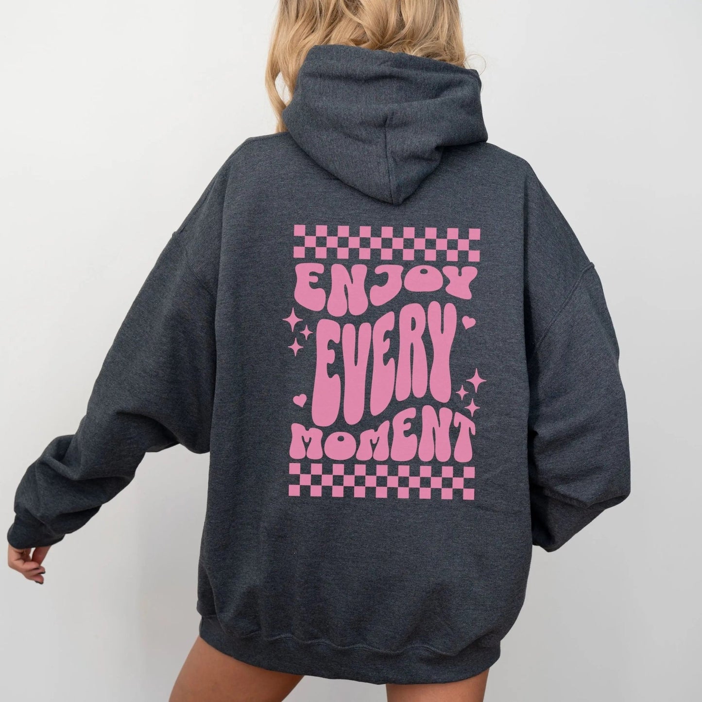 Enjoy Every Moment hoodie with retro checkerboard design, perfect for positive fashion and groovy vibes.