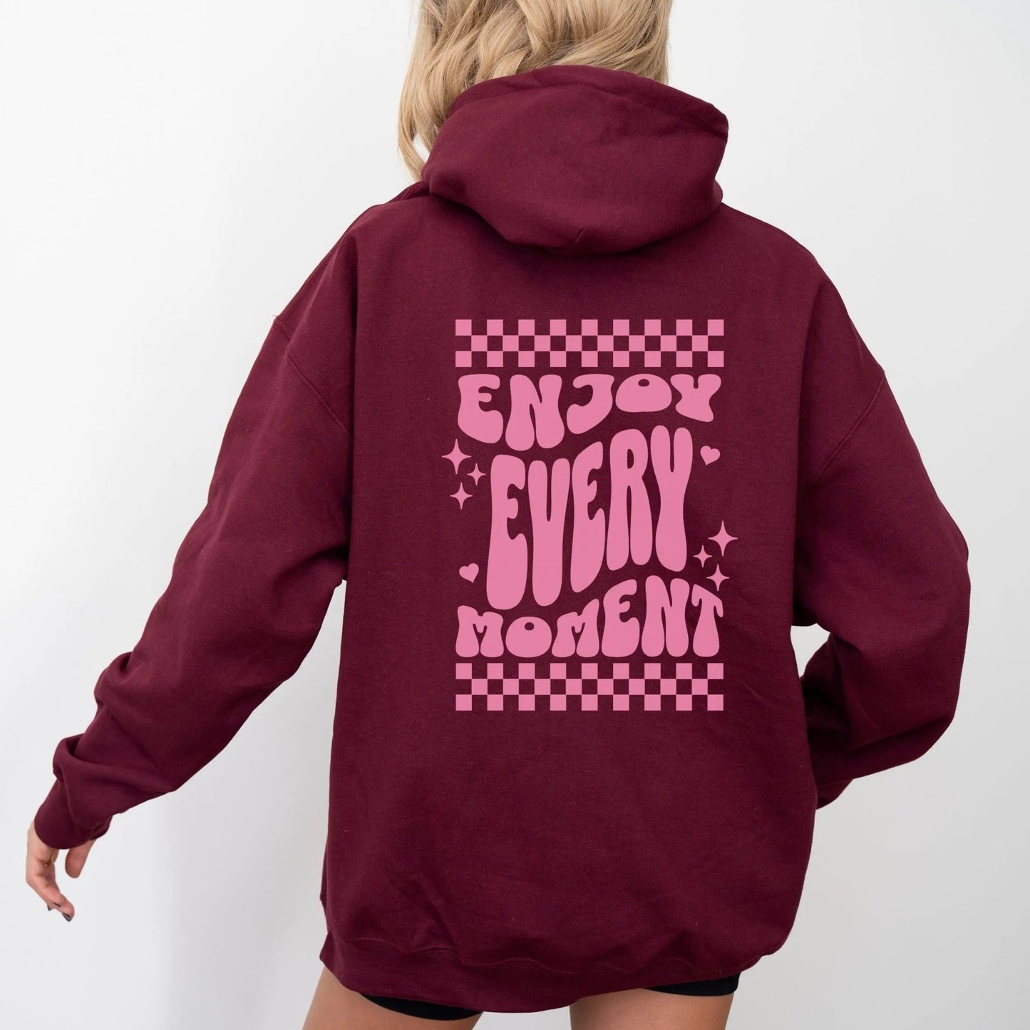 Enjoy Every Moment hoodie with retro checkerboard design, perfect for positive fashion and groovy vibes.