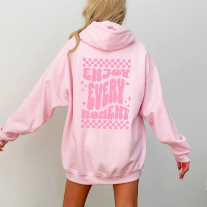 Enjoy Every Moment hoodie with retro checkerboard design, perfect for positive fashion and groovy vibes.