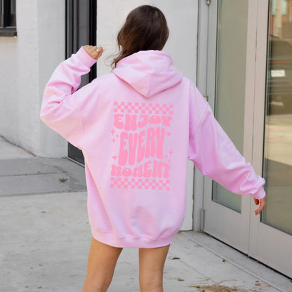 Enjoy Every Moment hoodie with retro checkerboard design, perfect for positive fashion and groovy vibes.