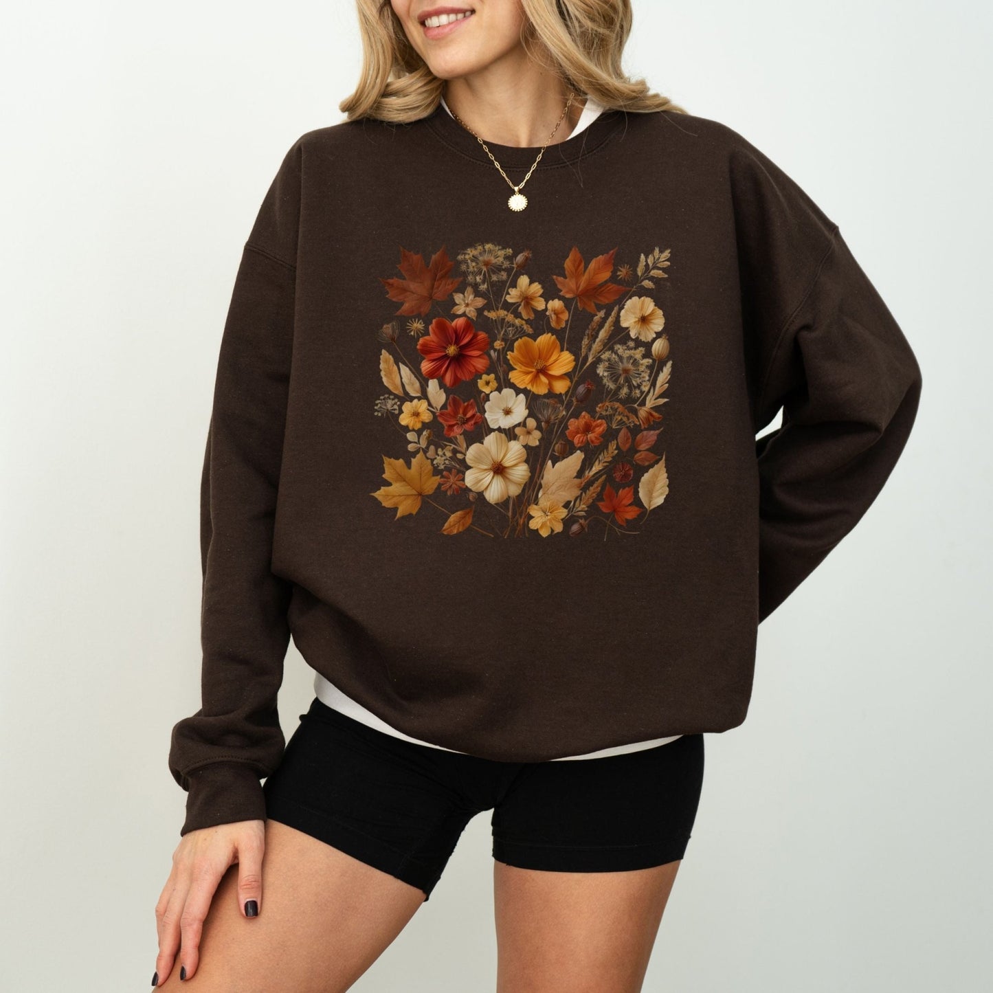 Fall floral sweatshirt with wildflower and autumn leaf design.