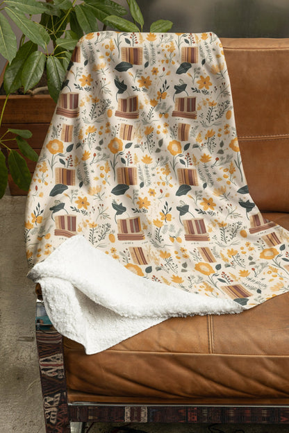 Floral book blanket with a cozy reading design, available in velveteen plush or sherpa fleece.