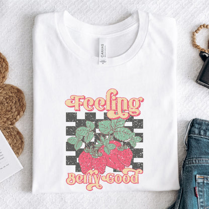 Vintage strawberry graphic t-shirt with retro font and checkerboard background, perfect for summer outfits and fruit lovers