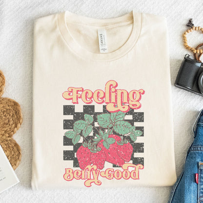 Vintage strawberry graphic t-shirt with retro font and checkerboard background, perfect for summer outfits and fruit lovers