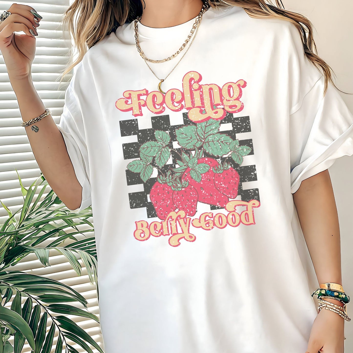 Vintage strawberry graphic t-shirt with retro font and checkerboard background, perfect for summer outfits and fruit lovers
