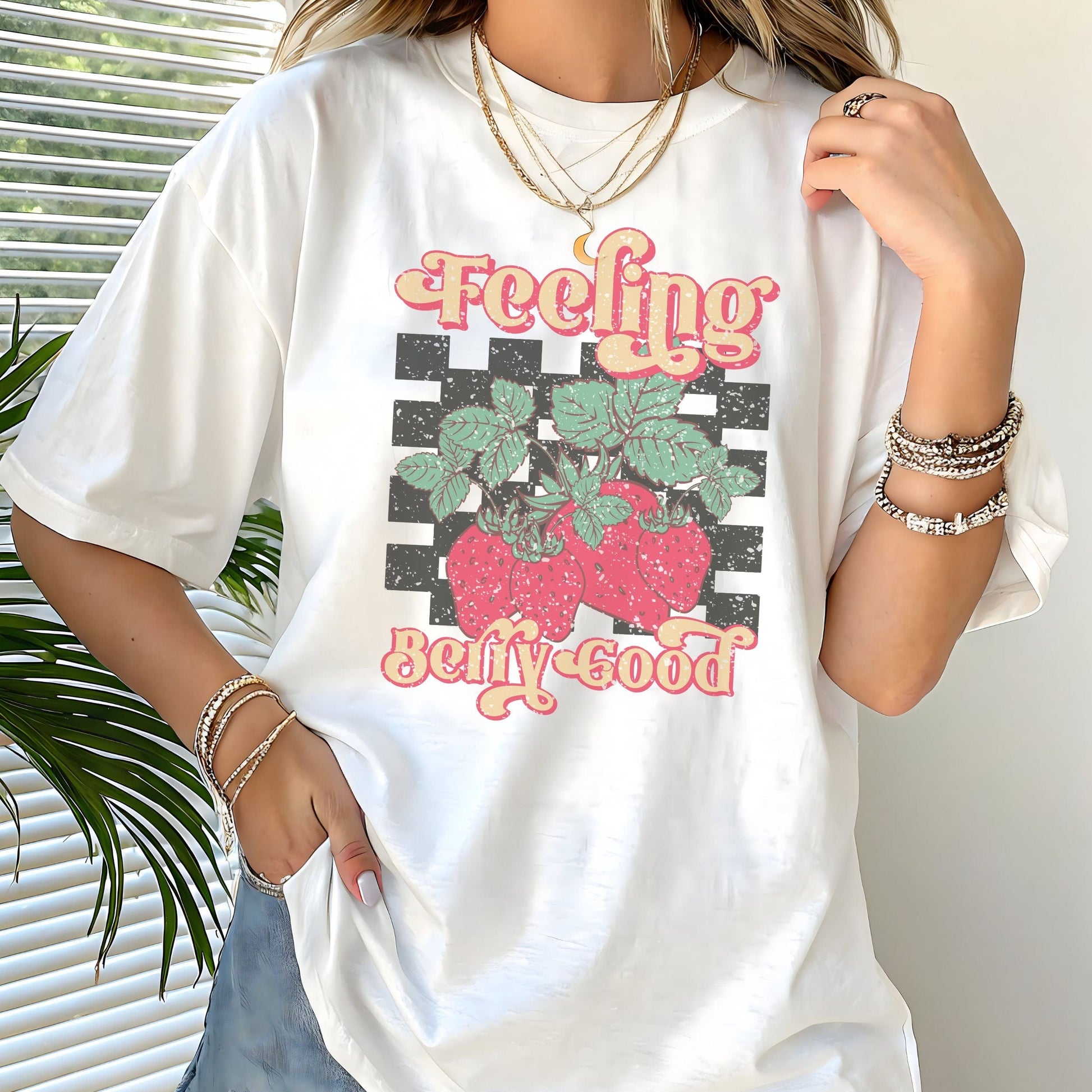 Vintage strawberry graphic t-shirt with retro font and checkerboard background, perfect for summer outfits and fruit lovers