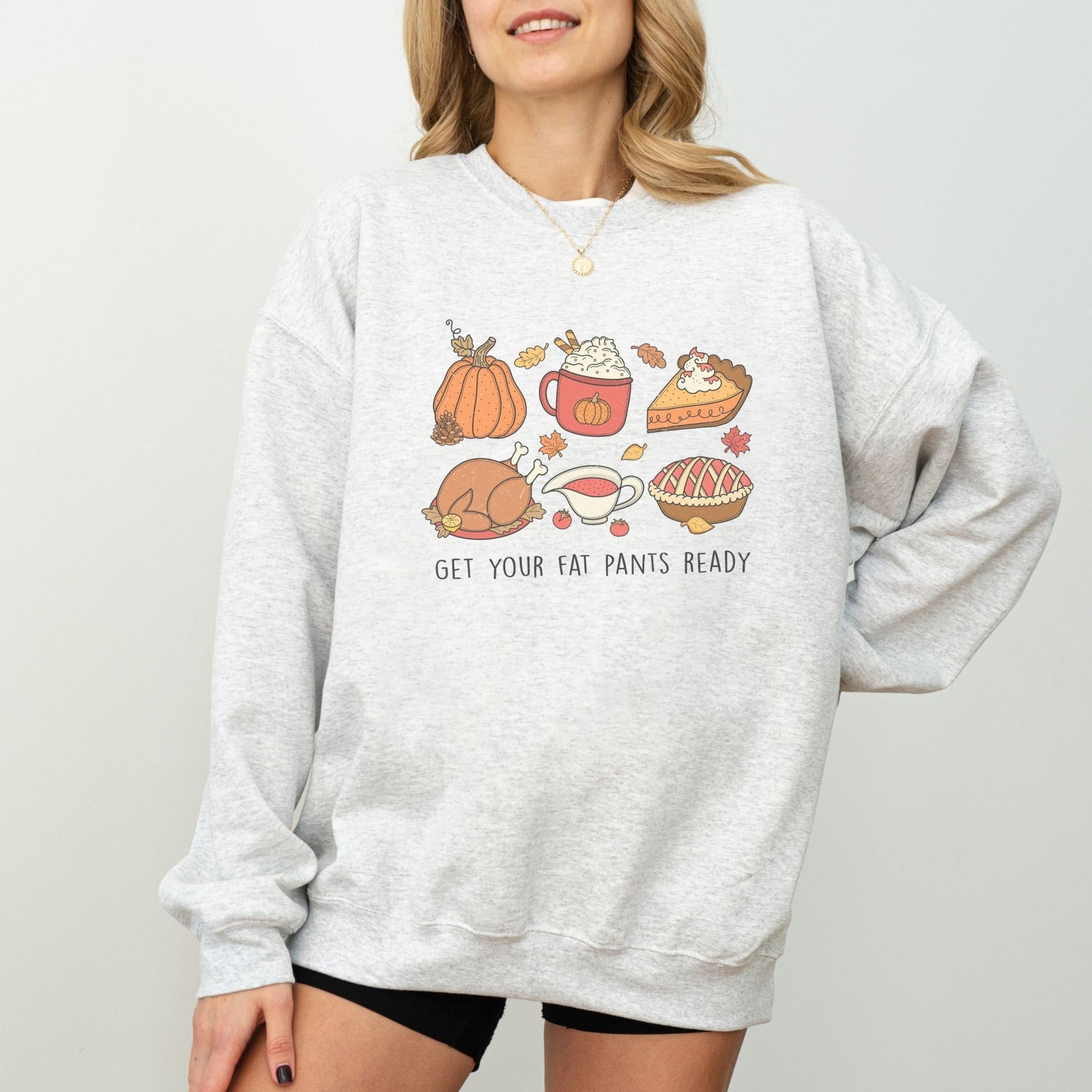 Thanksgiving sweatshirt with a festive food design and "Get Your Fat Pants Ready" text.